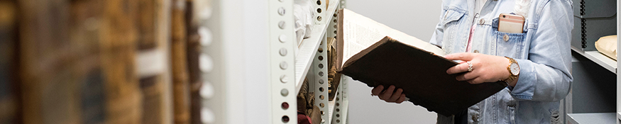 Student studying a rare book in Special Collections